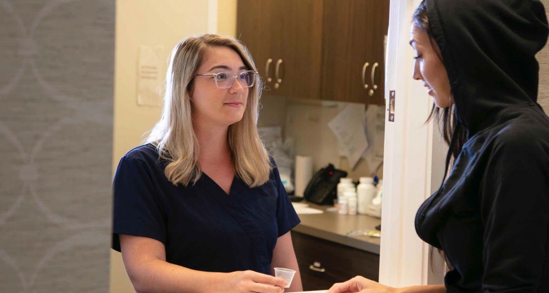 Two ladies partake in a intense conversation about the diverse drug and alcohol intervention methods, including the Johnson Model, Invitational Model, Systemic Family Model, ARISE Model, Motivational Interviewing, CRAFT, and the Field Model, underscoring their distinct approaches to wellness.